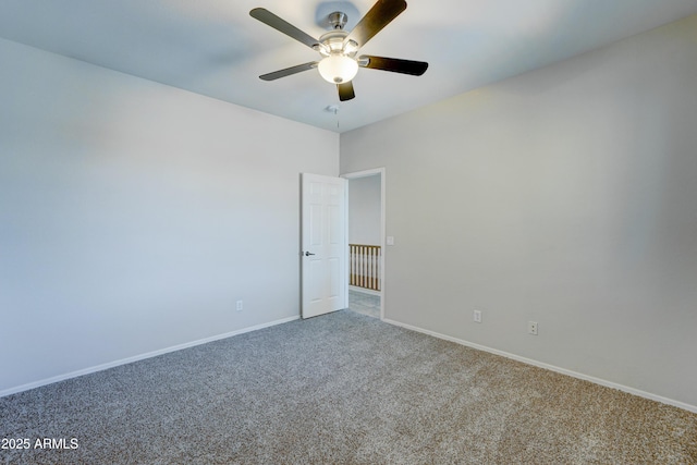 carpeted empty room featuring ceiling fan