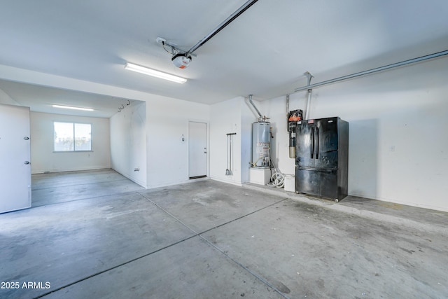 garage with black refrigerator, gas water heater, and a garage door opener