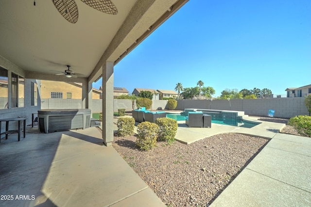 view of pool featuring ceiling fan, a hot tub, and a patio