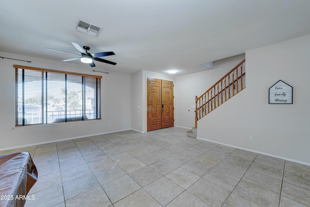 interior space with ceiling fan and light tile patterned flooring