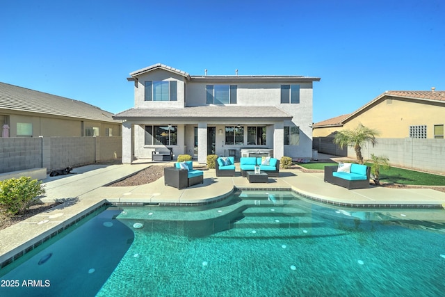 rear view of house featuring outdoor lounge area and a patio