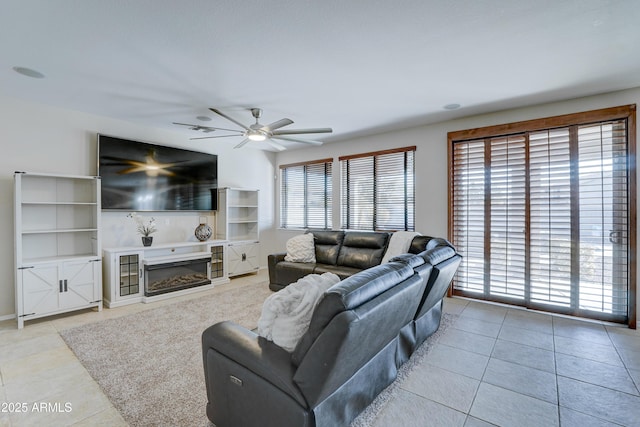 living room featuring ceiling fan and light tile patterned floors