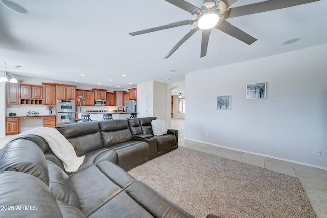 living room with ceiling fan and light tile patterned floors