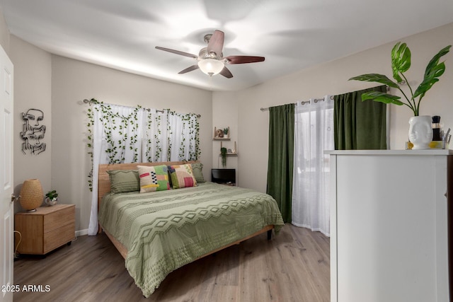 bedroom with ceiling fan and wood finished floors