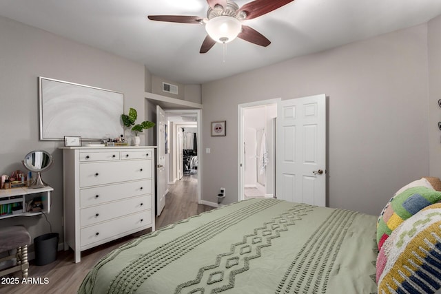 bedroom with visible vents, ceiling fan, and wood finished floors