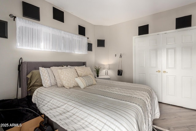 bedroom with a closet and wood finished floors