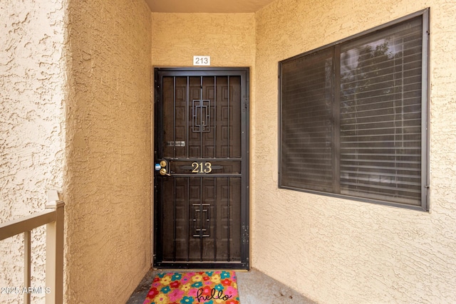 view of exterior entry with stucco siding