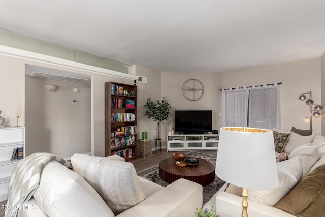 living area with visible vents and wood finished floors