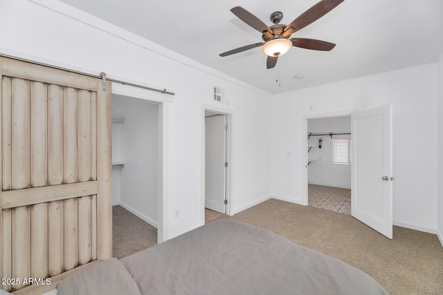 bedroom with baseboards, carpet, a closet, and a spacious closet