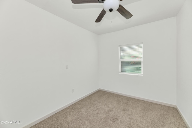 empty room with baseboards, ceiling fan, and carpet floors