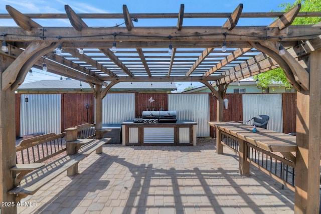 view of patio with grilling area, a pergola, and fence