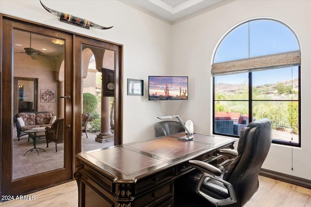 office area with light hardwood / wood-style flooring and ceiling fan