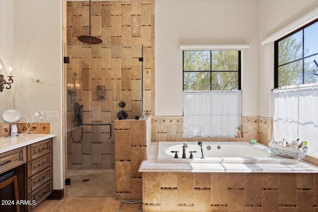 bathroom featuring vanity, shower with separate bathtub, and tile patterned flooring