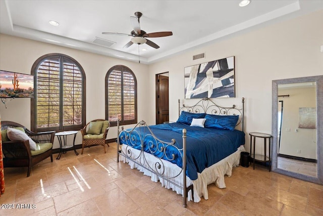 bedroom featuring a tray ceiling and ceiling fan