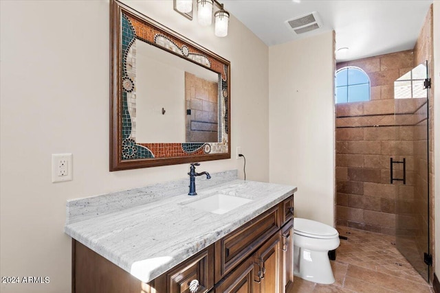 bathroom featuring vanity, toilet, and walk in shower