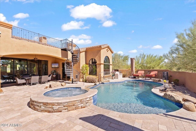 view of pool with an in ground hot tub, a patio area, and ceiling fan