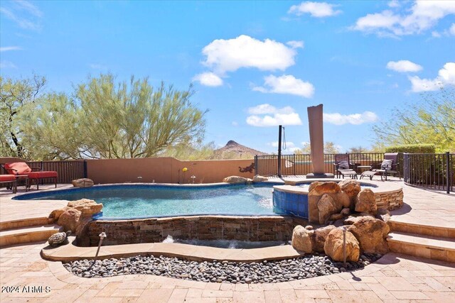 view of pool featuring a patio area and pool water feature