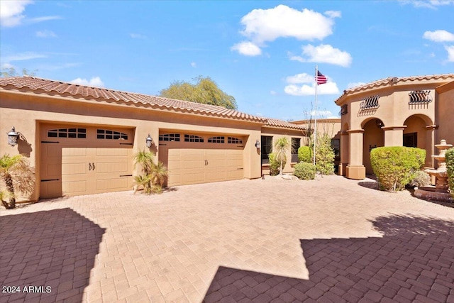 mediterranean / spanish house with a garage