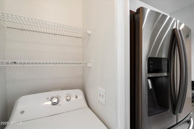 washroom featuring laundry area and washer / dryer