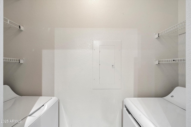 laundry area with washing machine and dryer, laundry area, and electric panel
