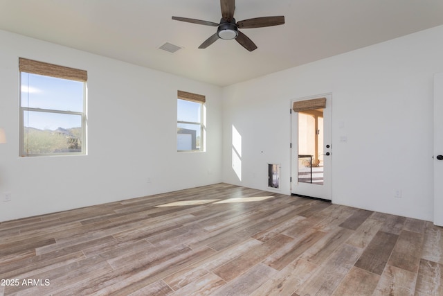 spare room with ceiling fan and light hardwood / wood-style floors