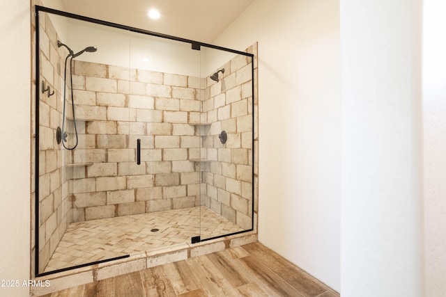 bathroom featuring walk in shower and wood-type flooring