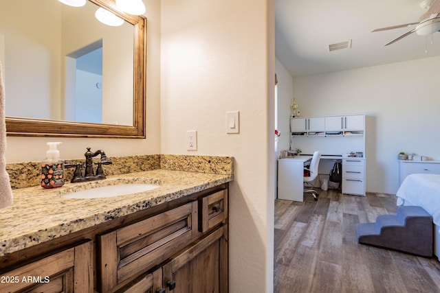 bathroom featuring hardwood / wood-style flooring, vanity, and ceiling fan