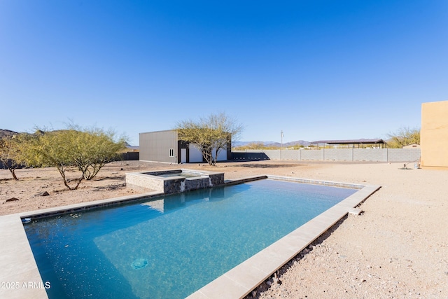 view of swimming pool with an in ground hot tub