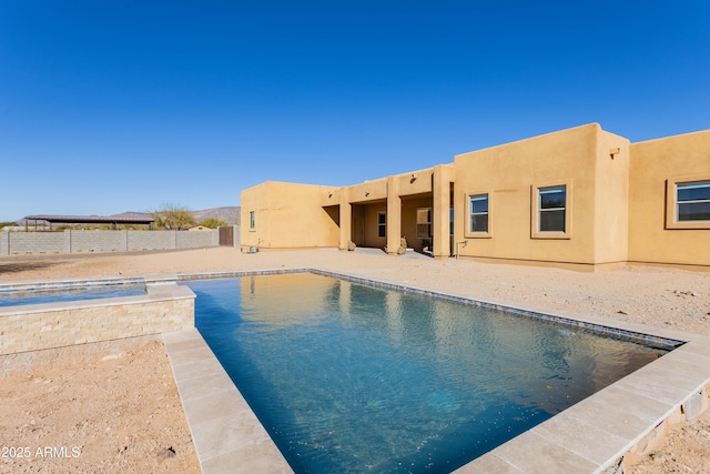 view of pool with a jacuzzi