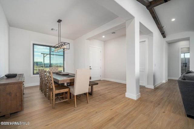 dining space featuring light wood finished floors, plenty of natural light, and visible vents