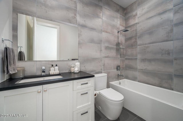 full bathroom with tasteful backsplash, toilet, vanity, shower / washtub combination, and tile walls