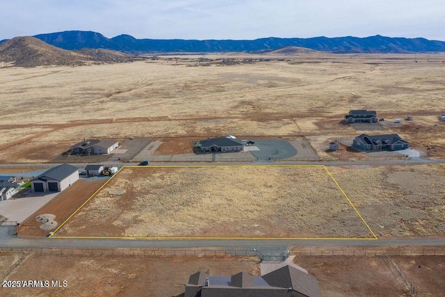 birds eye view of property with a mountain view