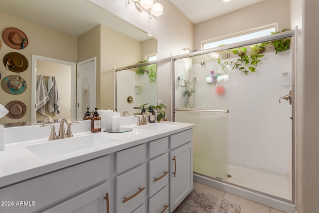 bathroom with tile patterned floors, vanity, and an enclosed shower