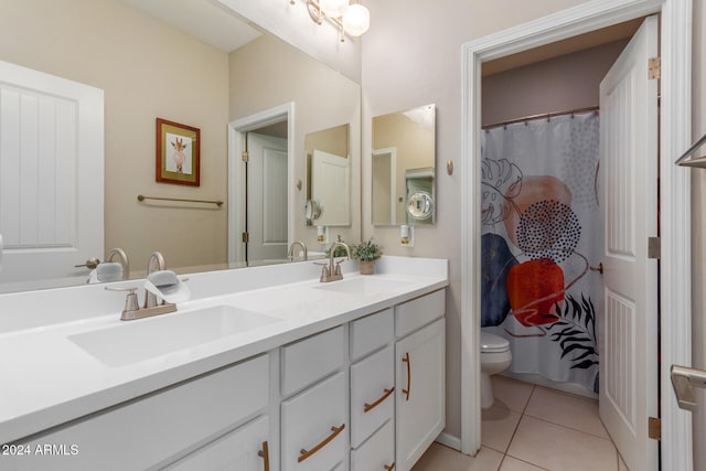 bathroom with tile patterned flooring, vanity, toilet, and curtained shower