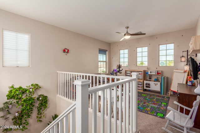 bedroom with carpet flooring, ceiling fan, and a crib