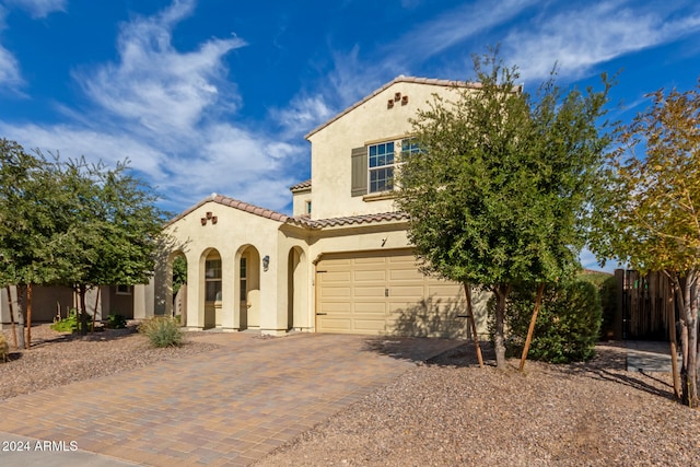 mediterranean / spanish-style home with a garage