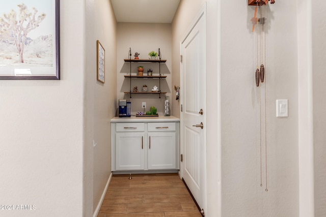 corridor with light hardwood / wood-style floors