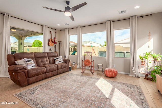 living room featuring light hardwood / wood-style floors and ceiling fan