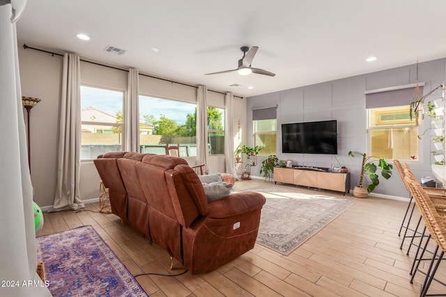 living room with ceiling fan and light hardwood / wood-style floors