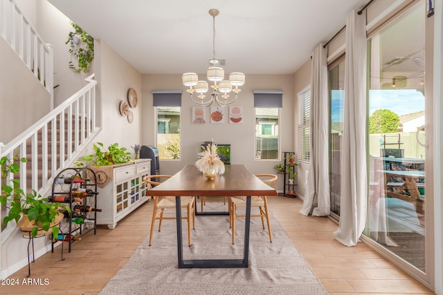 dining area with a notable chandelier and light wood-type flooring