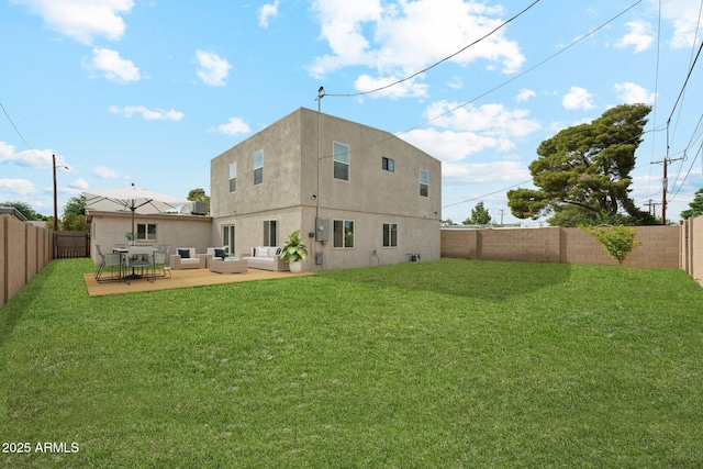 rear view of property featuring an outdoor living space, stucco siding, and a patio