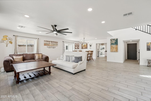 living area featuring recessed lighting, ceiling fan, baseboards, a chandelier, and light wood-style floors
