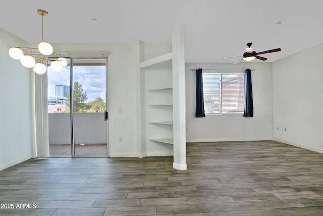 interior space with multiple windows, a notable chandelier, and wood finished floors