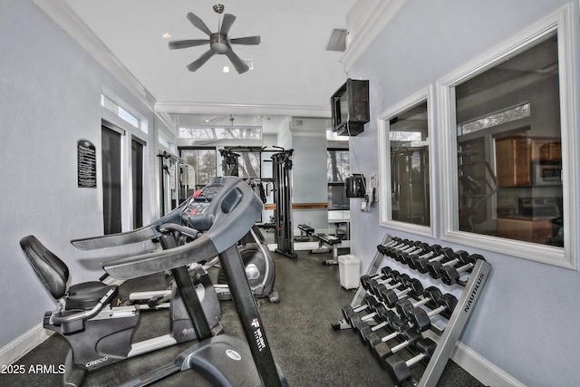 workout area featuring baseboards, ceiling fan, and crown molding