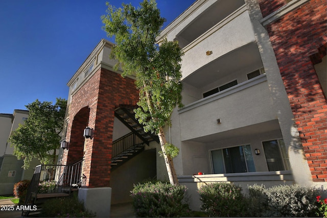 view of property featuring stairway