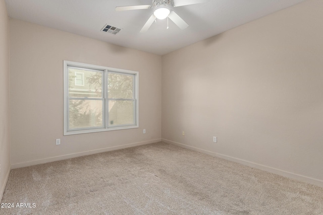 unfurnished room with ceiling fan and light carpet