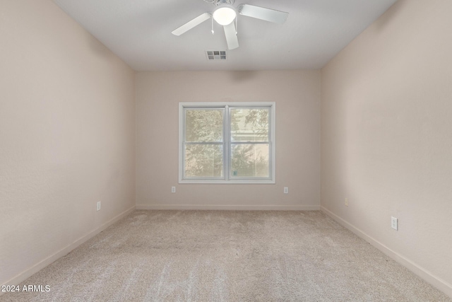 carpeted empty room featuring ceiling fan