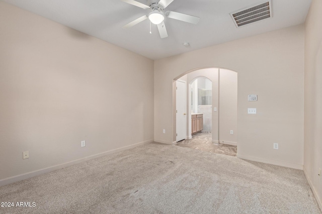 carpeted spare room with ceiling fan