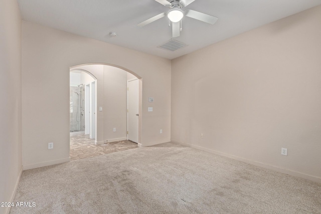 carpeted empty room featuring ceiling fan