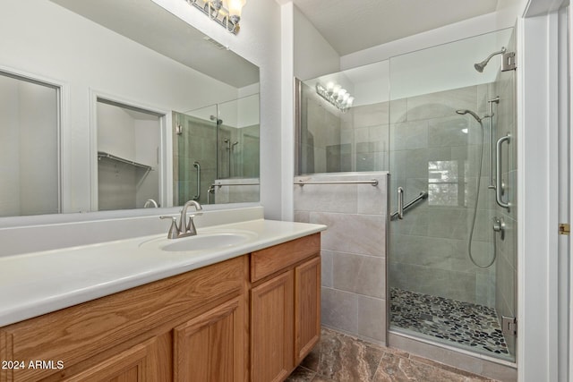 bathroom with vanity and a shower with shower door